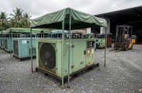 2nd hand generator for sale at a Malaysian used genset yard: soundproofed diesel set on gravel
